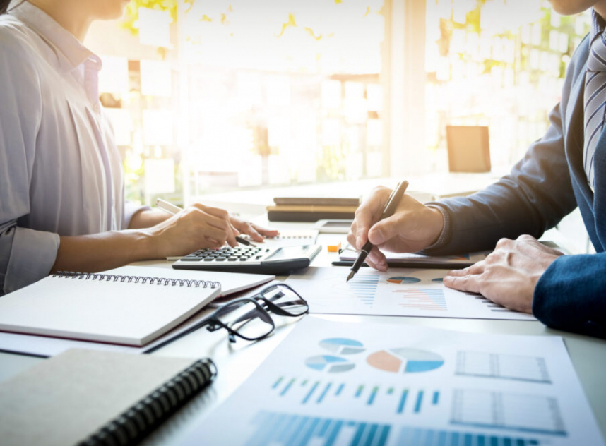 business man financial inspector and secretary making report, calculating or checking balance. Internal Revenue Service inspector checking document. Audit concept