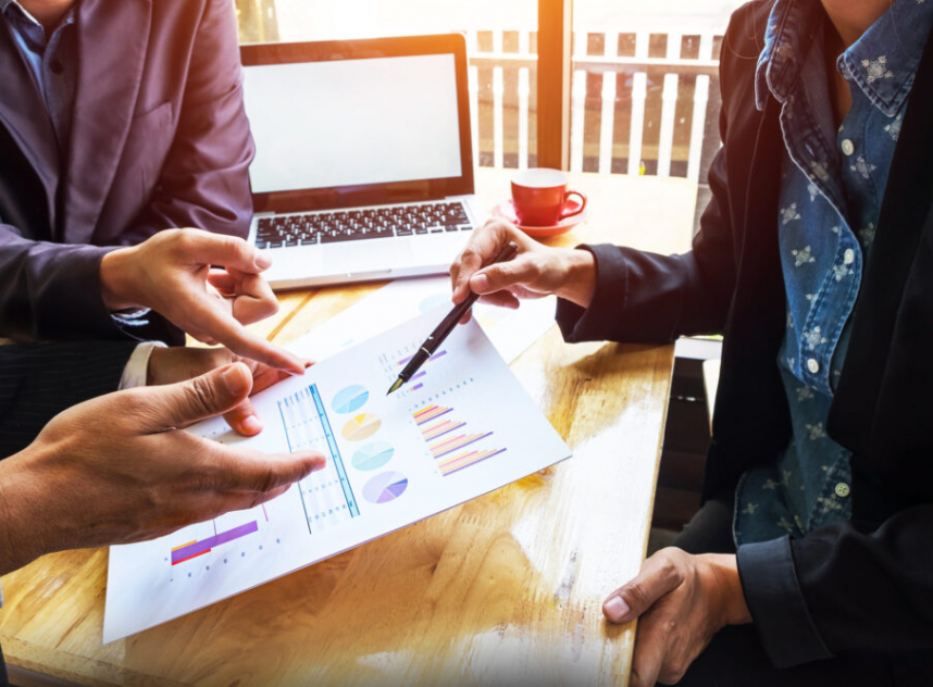 Business team working on a new business plan with modern digital computer